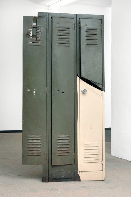 Edition by Olaf Metzel. Beige and olive green metal locker, destroyed and reassembled with an angle grinder. The object is reminiscent of cubist compositions